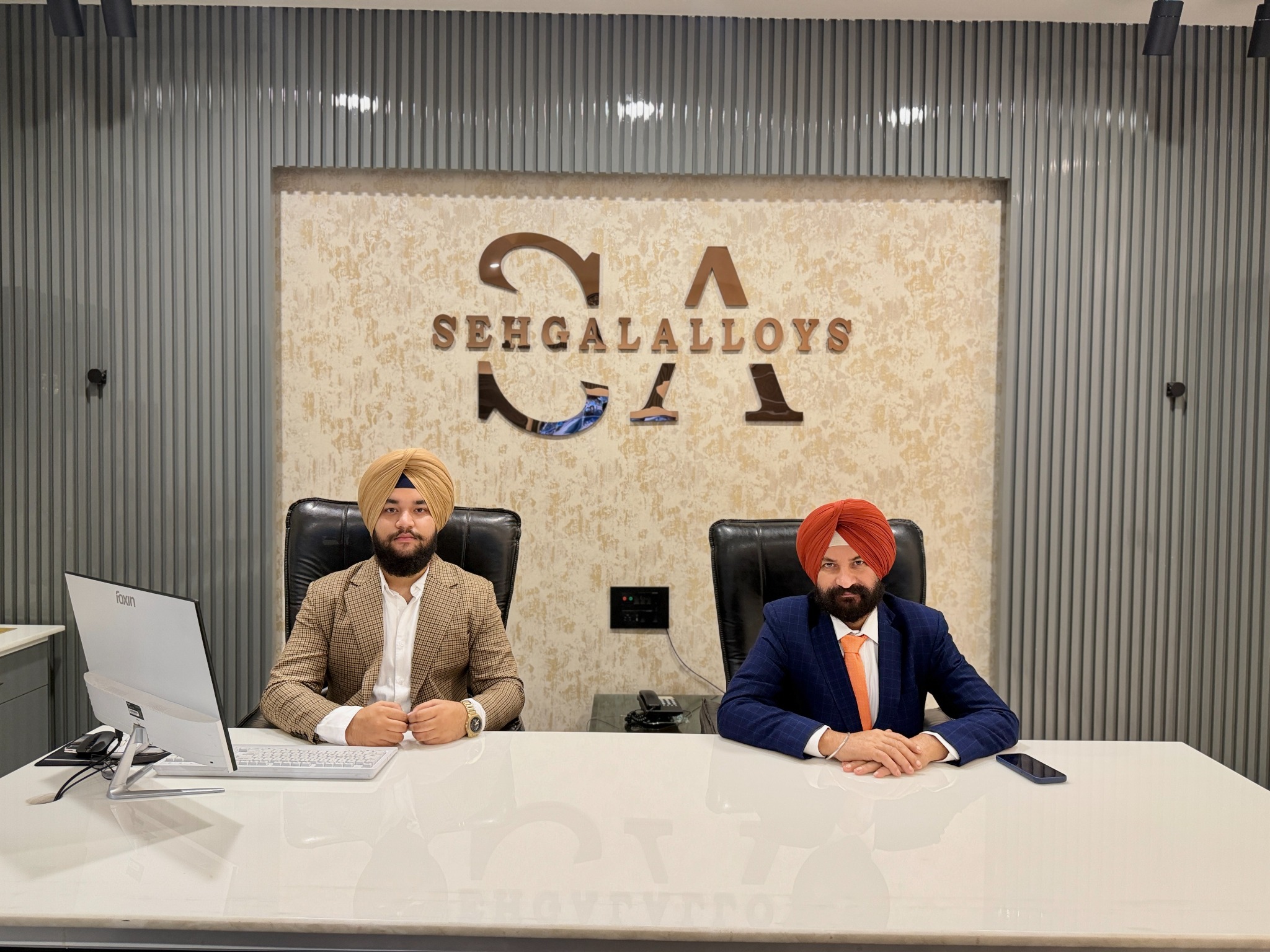 Ronak Sehgal, left, and Jaswinder Singh, right, at the Sehgal Alloys office